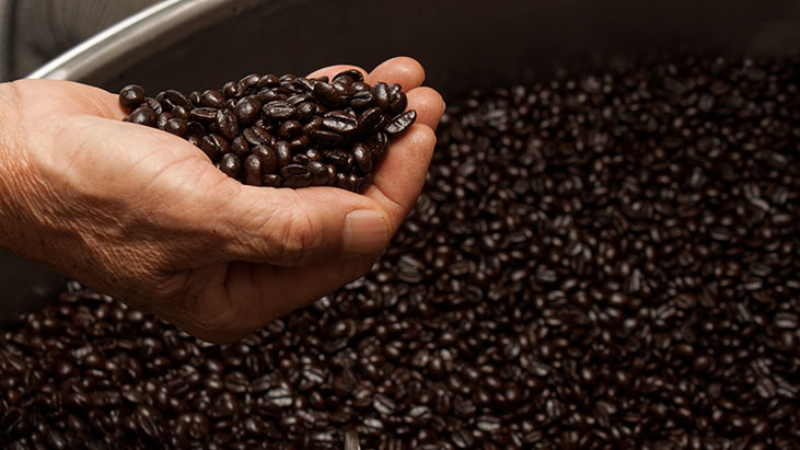 roasted coffee beans hand